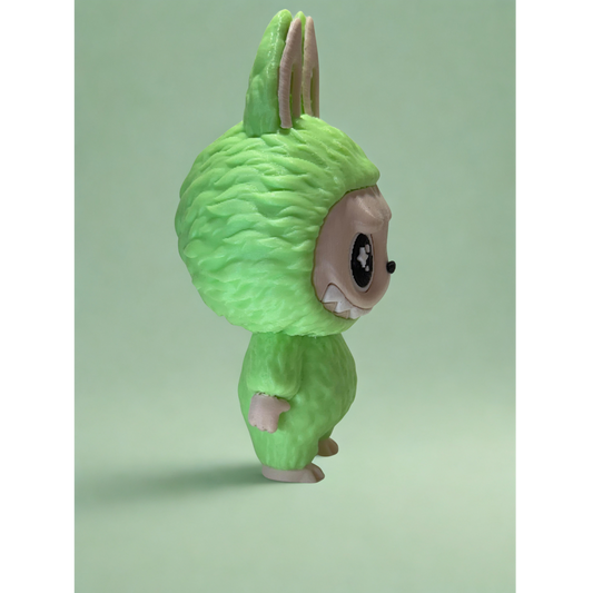 Glow-in-the-dark Labubu figurine illuminating message plaque in the dark, showcasing PLA-glow filament effect.