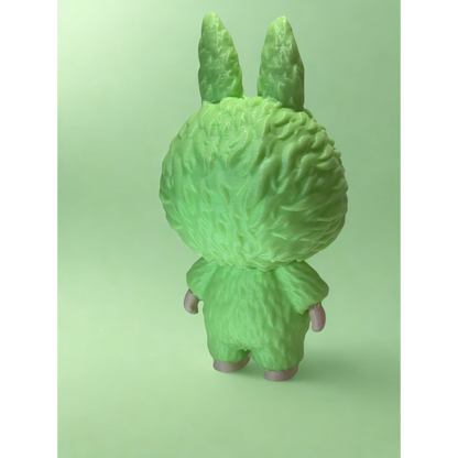 Close-up of glowing green Labubu figurine radiating light in dark environment, showcasing glow-in-the-dark PLA material.